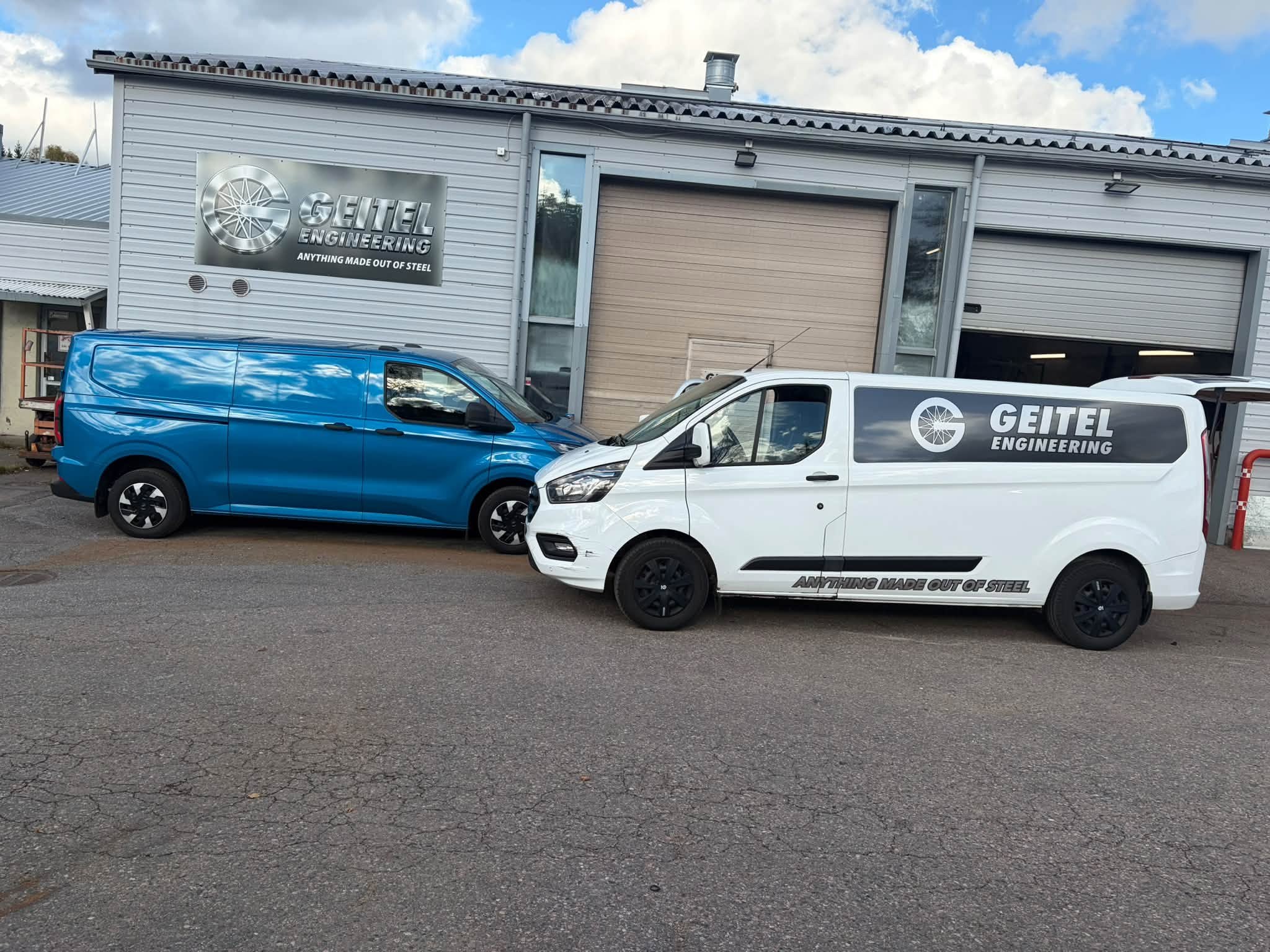 The Geitel Engineering workshop with two vans parked outside.