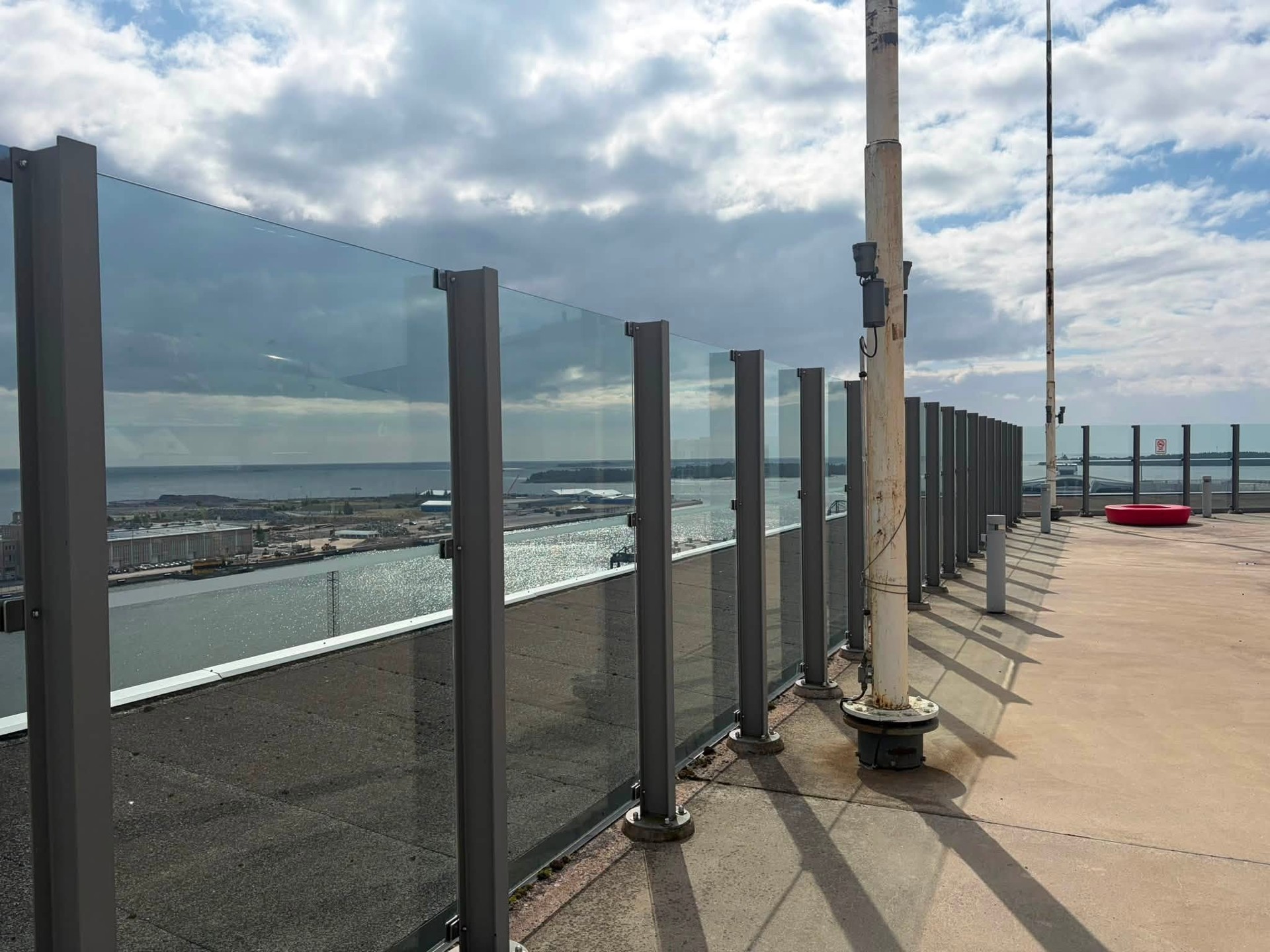 Glass railings fitted between metal posts on an outdoor terrace.