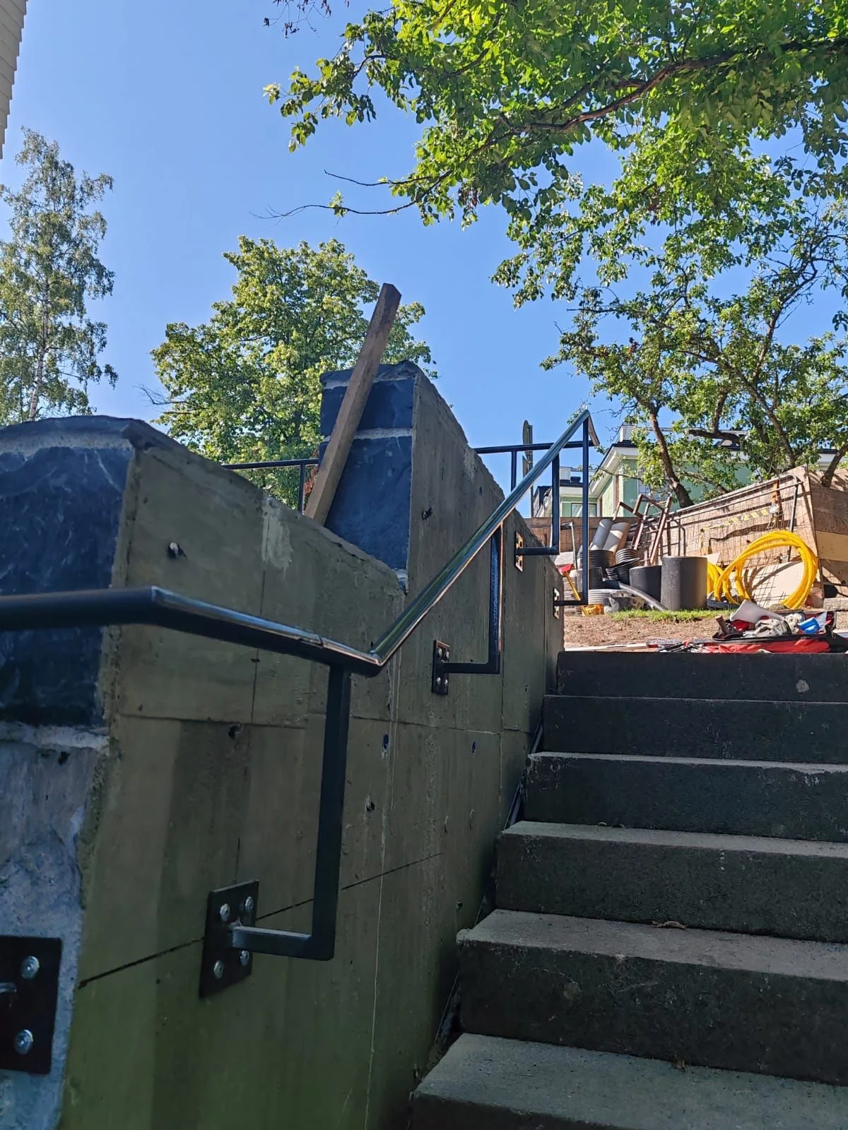 A black handrail and railing beside outdoor stairs at the Mannerheim Museum.