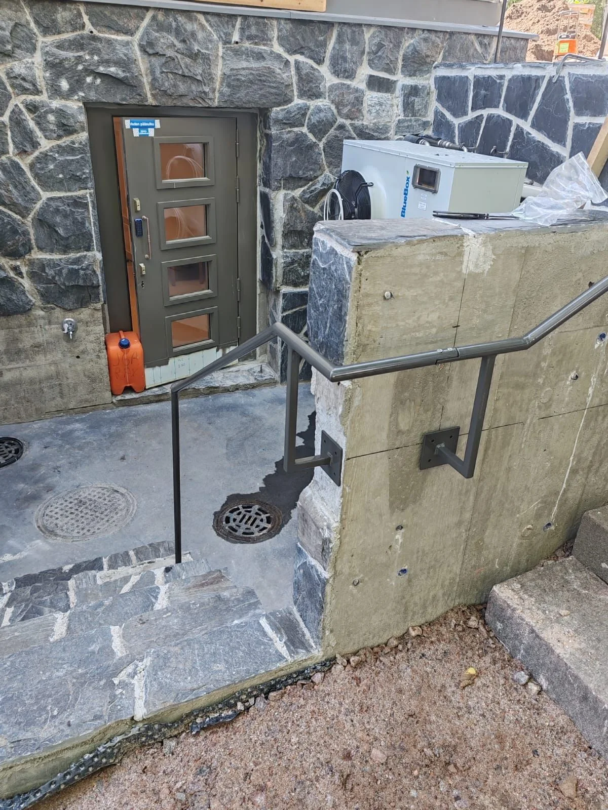 A stair railing and handrail outside the museum entrance.