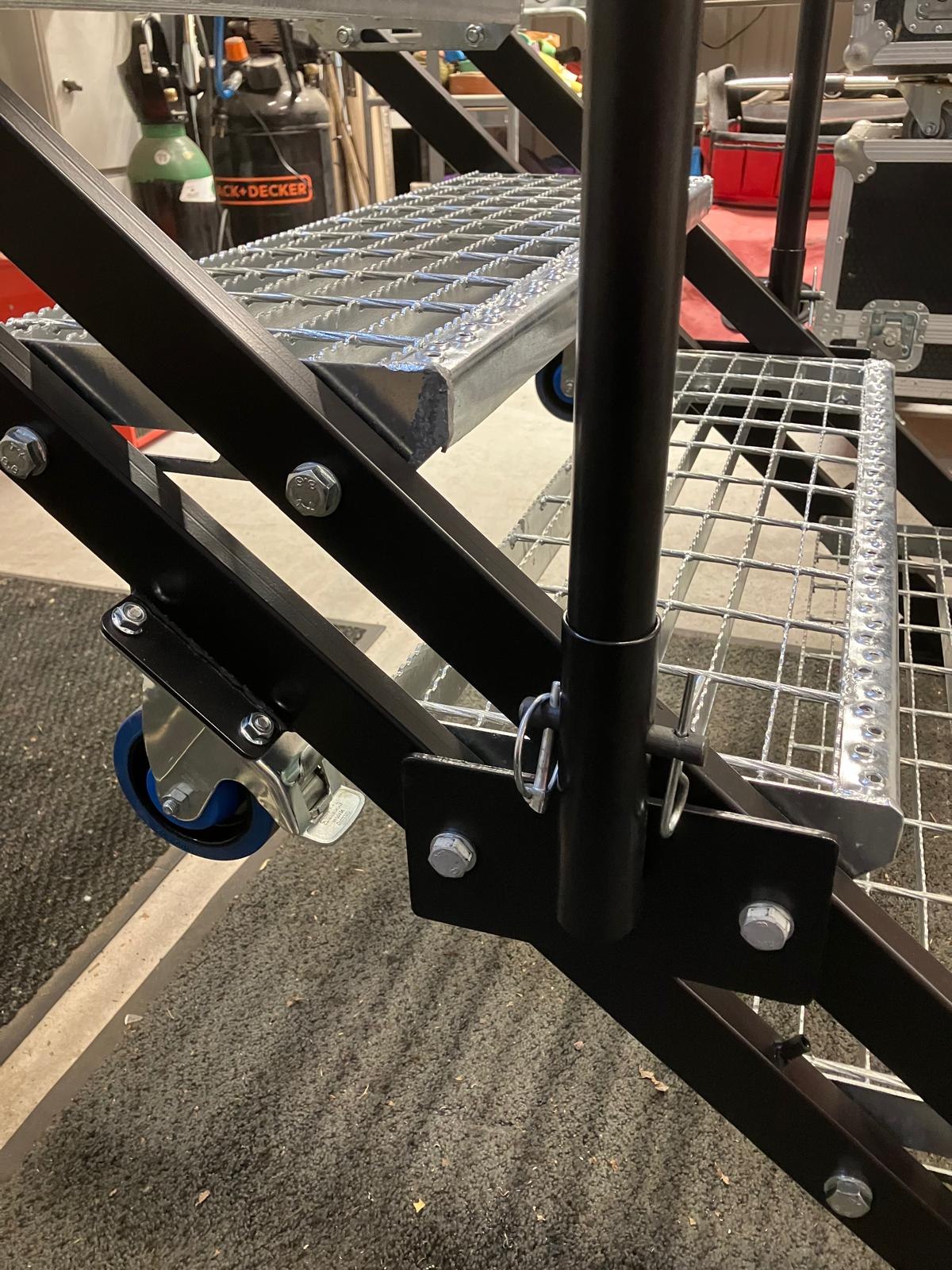 Close-up of a bolted steel stair connection, tread and railing.