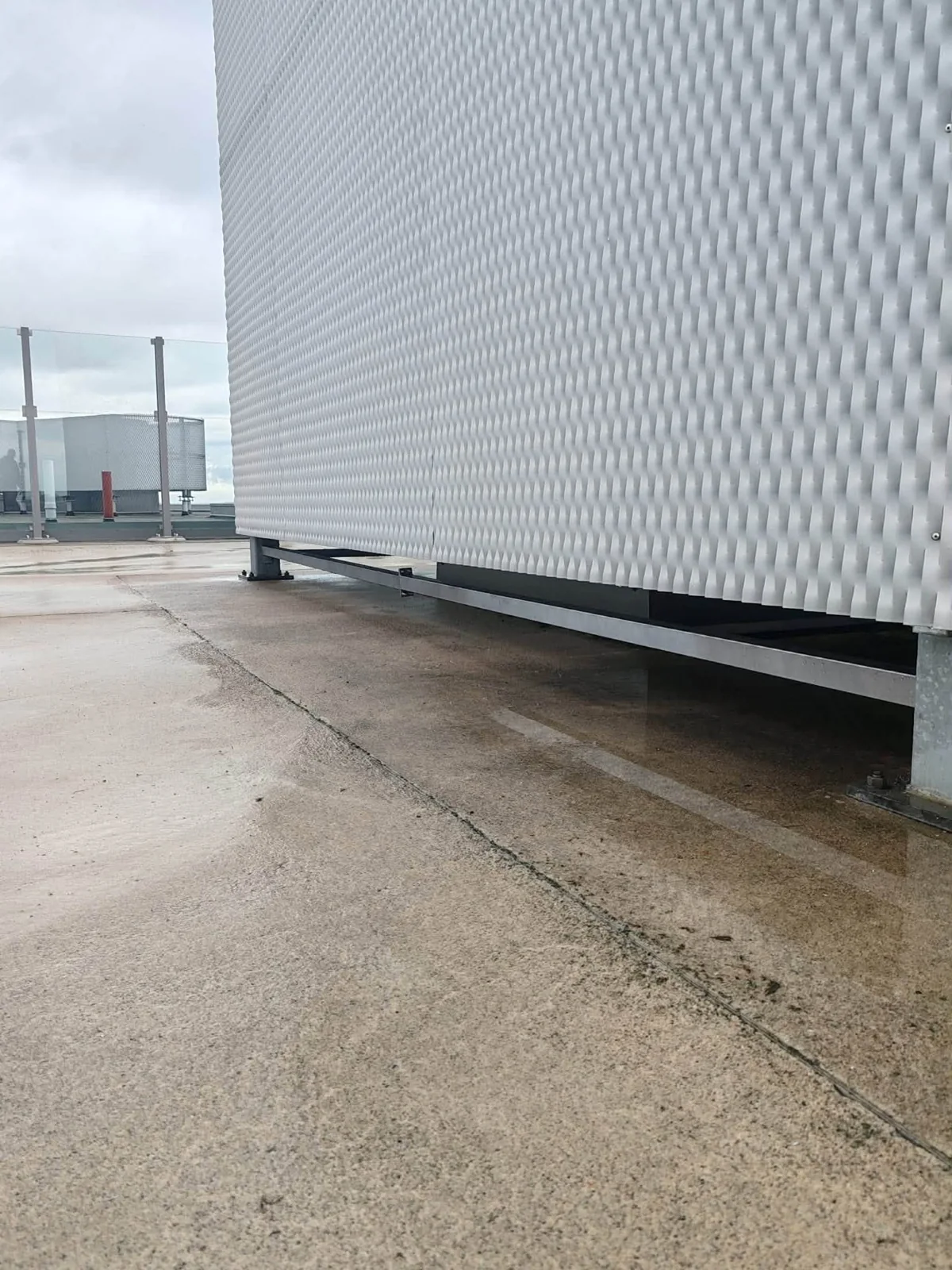 A large mesh-clad structure on the rooftop.