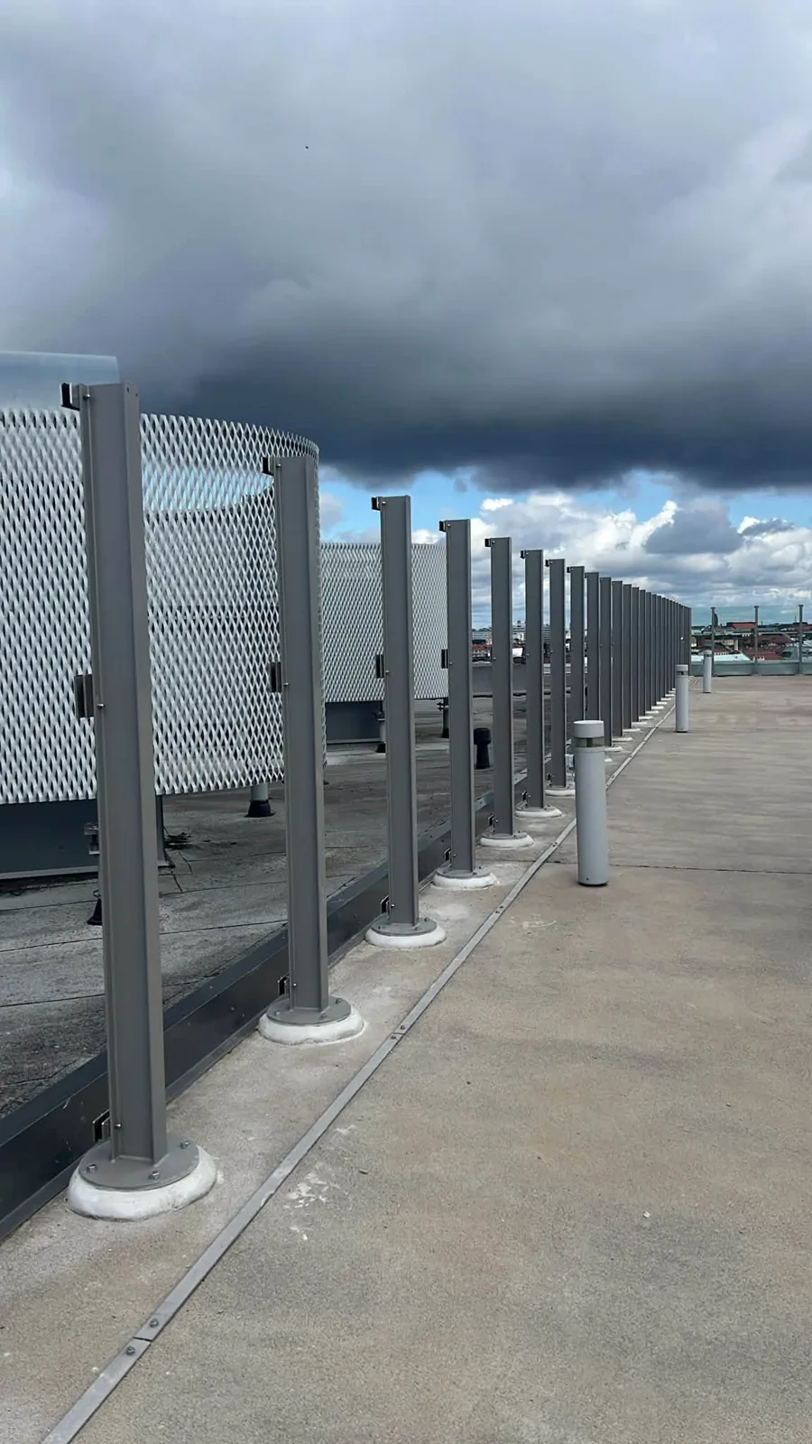 A row of metal glass-railing posts on the rooftop.